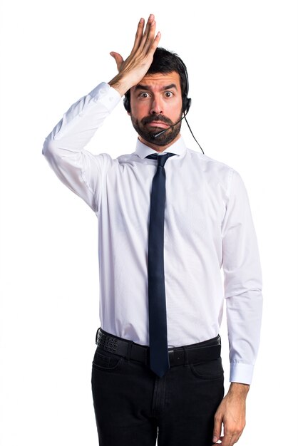 Young man with a headset having doubts