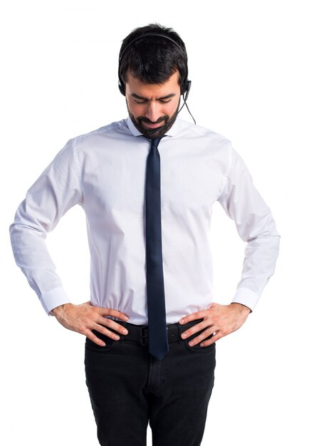 Young man with a headset looking down