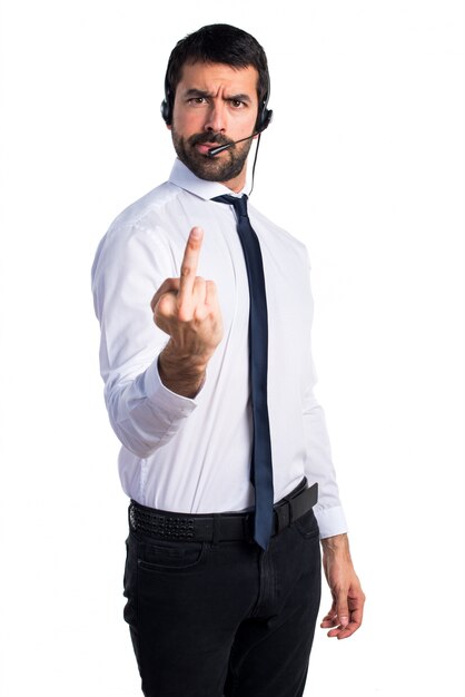 Young man with a headset making horn gesture