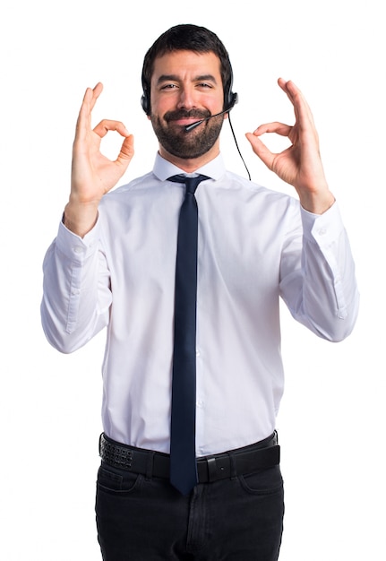 Free photo young man with a headset making ok sign