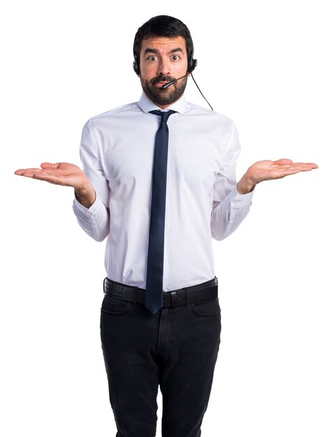 Young man with a headset making unimportant gesture