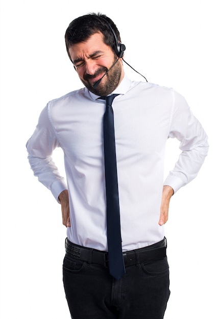 Young man with a headset with back pain