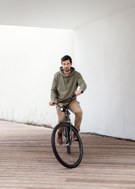 Young man with his bike in a tunnel