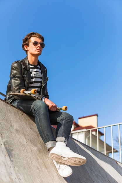 Young man with his skateboarding at the skate park