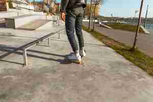 Free photo young man with his skateboarding at the skate park