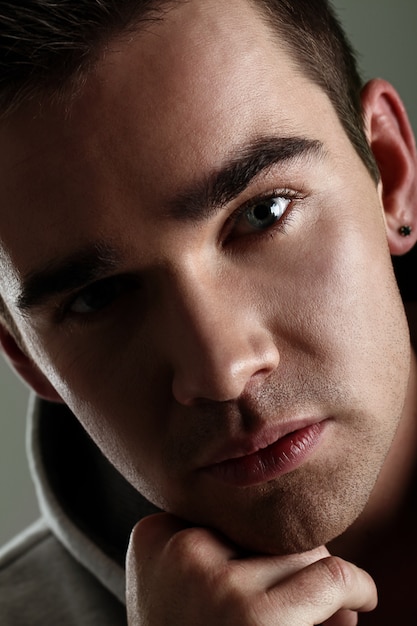 Young man with hoodie posing