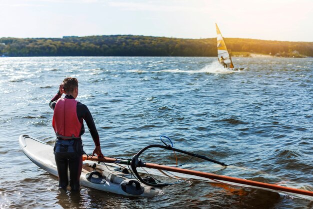 Young man with kitesurf board