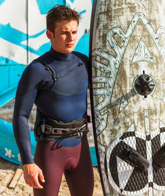 Young man with kitesurf board