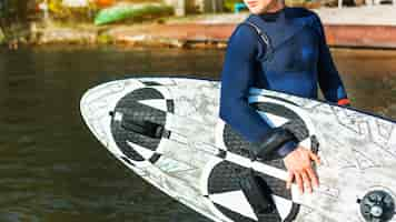 Free photo young man with kitesurf board