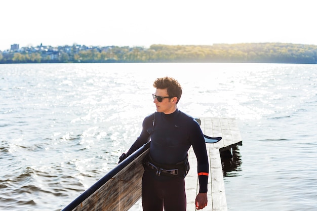 Young man with kitesurf board