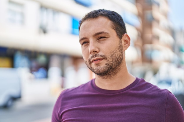 Young man with relaxed expression standing at street