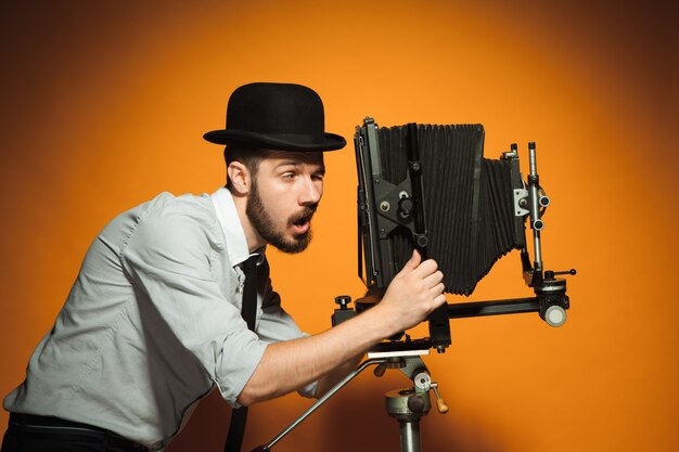 Young man with retro camera