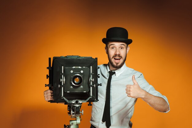 Young man with retro camera