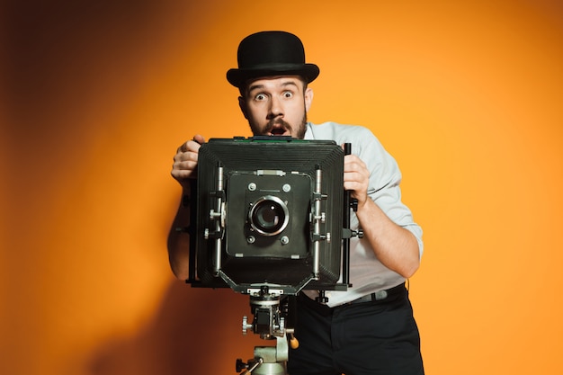 Young man with retro camera