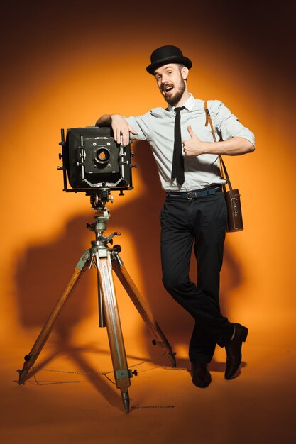 Young man with retro camera