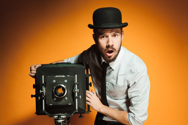 Young man with retro camera