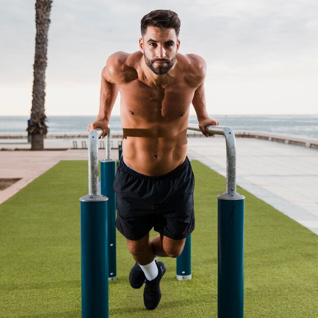 Young man with six packs working out