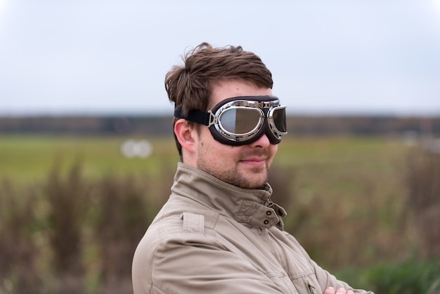 Young man with steampunk aviator goggles