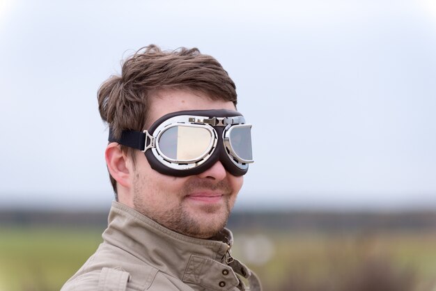 Young man with steampunk aviator goggles