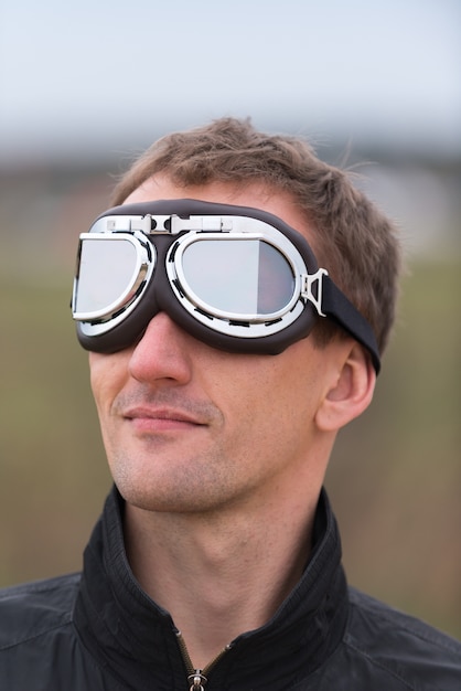 Young man with steampunk aviator goggles