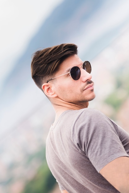 Young man with sunglasses by the sea