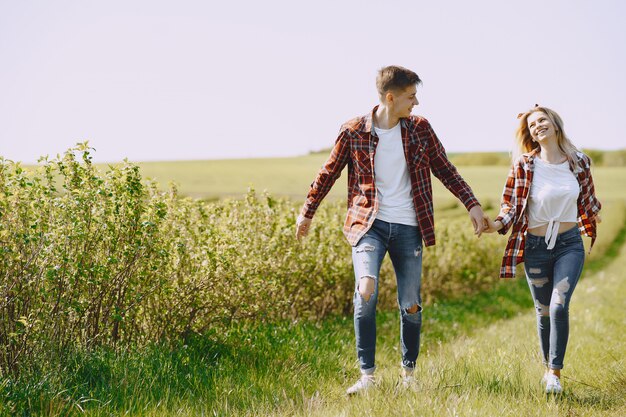 Young man and woman couple in a summer field