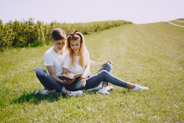 Young man and woman couple in a summer field