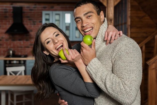 Young man and woman having an apple