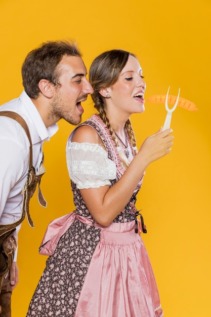 Free photo young man and woman holding a grill fork