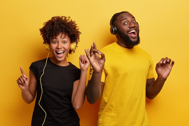 Young man and woman listening to music in headphones