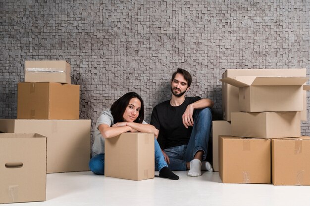 Young man and woman preparing boxes for relocation