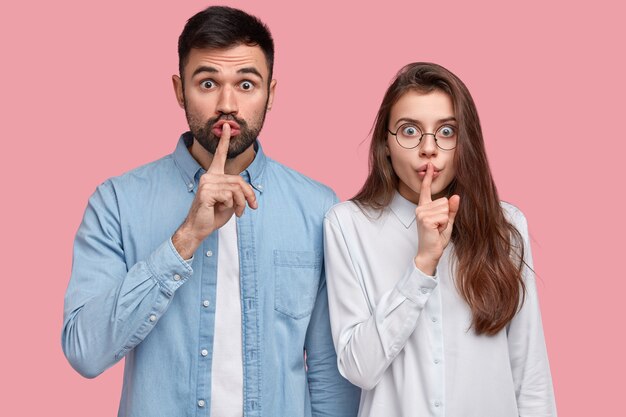 Young man and woman in shirts posing