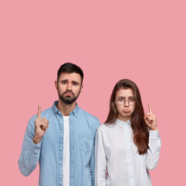 Young man and woman in shirts posing