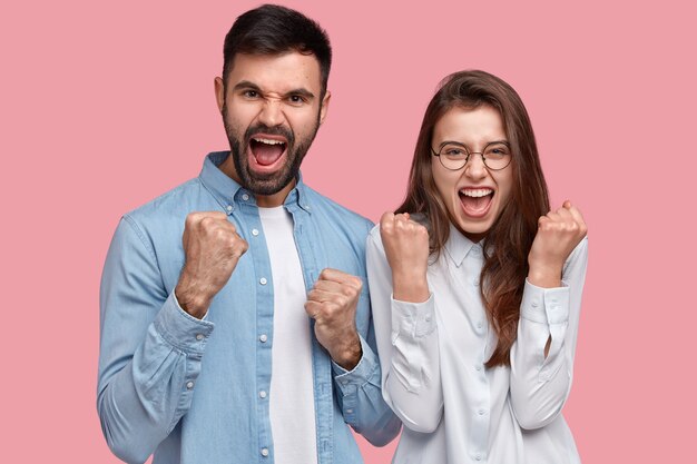 Young man and woman in shirts posing