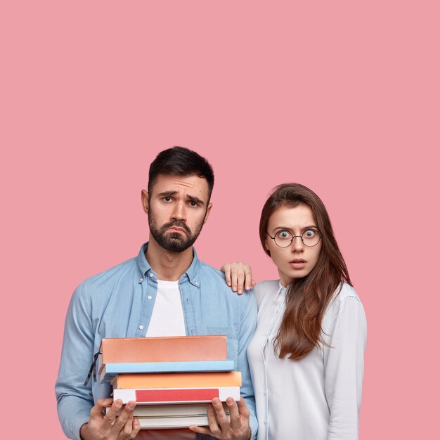 Young man and woman in shirts posing