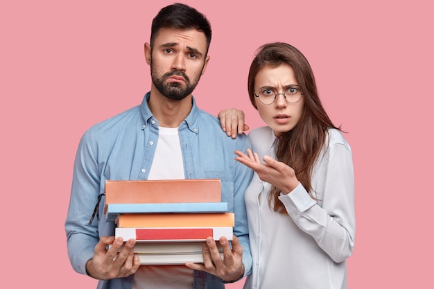 Young man and woman in shirts posing