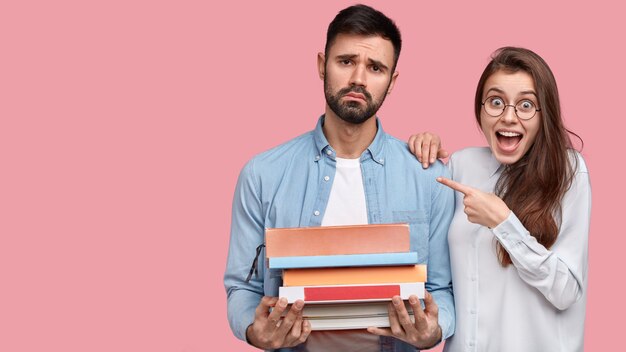 Young man and woman in shirts posing