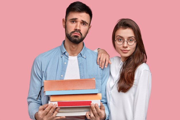 Young man and woman in shirts posing