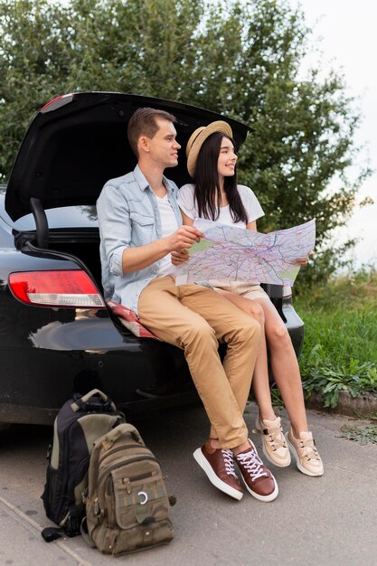 Young man and woman taking a break on the road