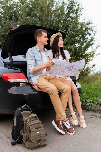 Young man and woman taking a break on the road