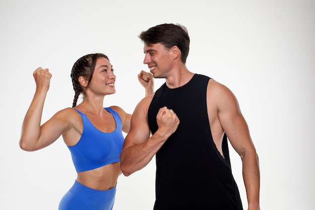 Young man and woman training together for bodybuilding