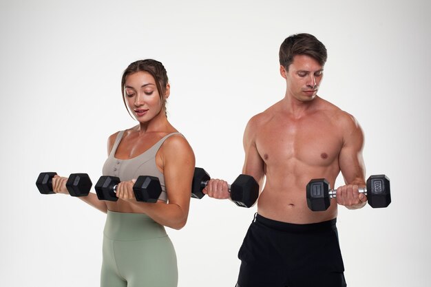 Young man and woman training together for bodybuilding