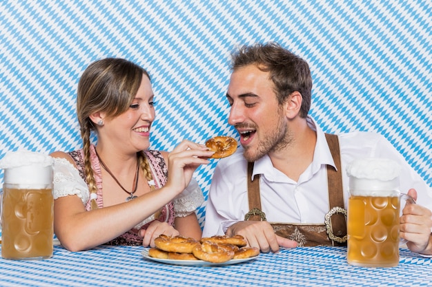 Young man and woman trying pretzels