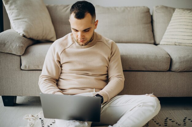 Young man working from home on laptop