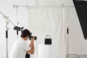 Free photo young man working in his photography studio