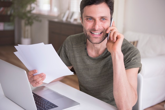 Young man working at home with his laptop