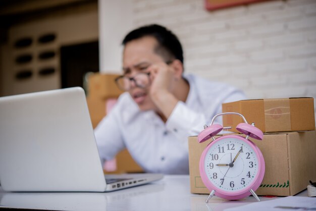 Young man working marketing online with laptop and box post