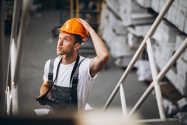 Young man working at a warehouse with boxes