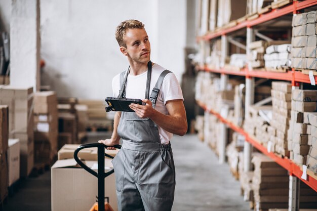 Young man working at a warehouse with boxes