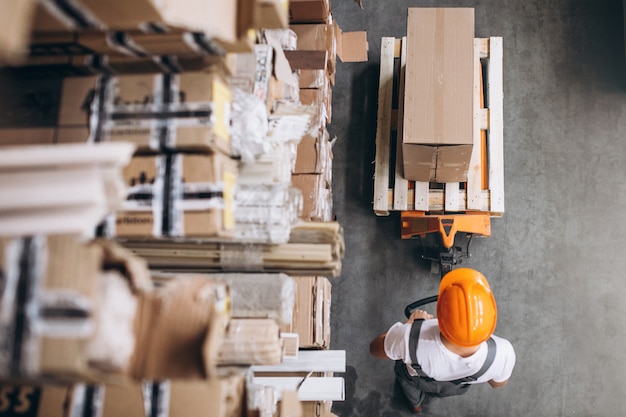 Young man working at a warehouse with boxes